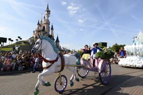 Crowds watch as Snow White and her prince ride past on a carriage during the Main Street Parade at Disneyland Paris.