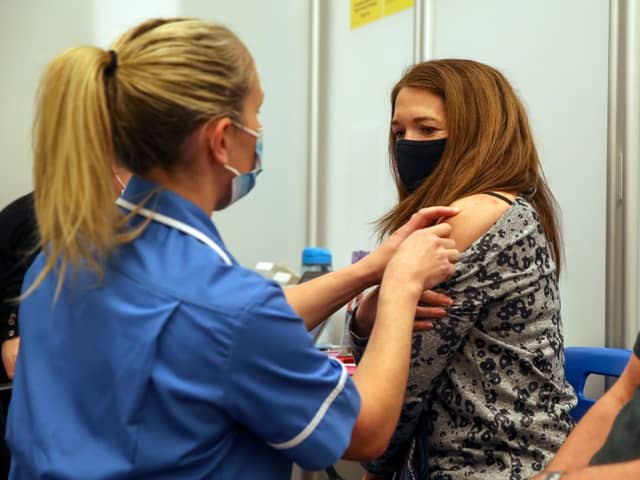 Caroline Nicolls receives an injection of the Moderna Covid-19 vaccine administered by nurse Amy Nash, at the Madejski Stadium, Reading (Getty Images)