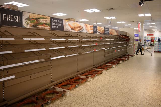 A shopper peruses near-empty bread shelves at a supermarket in the centre of York, northern England, during the first lockdown (Getty Images)