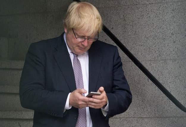 The PM has faced criticism in recent weeks over the use of his personal mobile. (Photo by JUSTIN TALLIS/AFP via Getty Images)