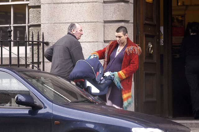 Irish singer Sinead O'Connor leaves Holles Street Maternity Hospital with her new baby son Shane on March 13, 2004