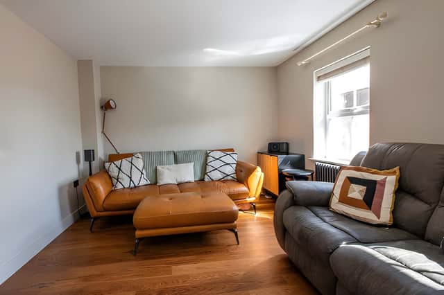 Two front-facing windows bring natural light into the spacious first-floor lounge