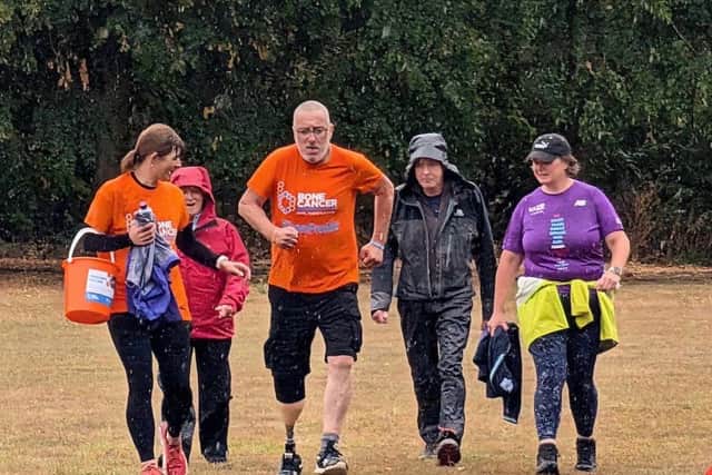Malcolm determined to cross the finish line in the rain to raise money for Freddie's Future. 