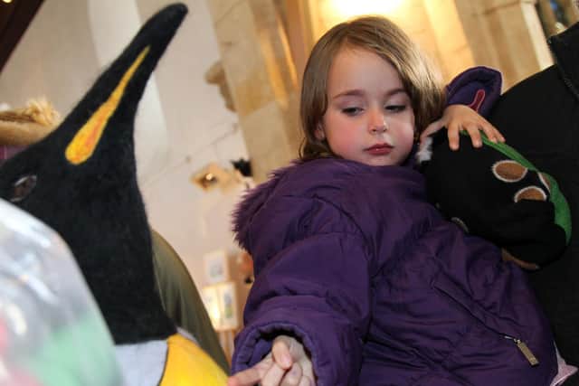 Adele Pratley checks to see if the life-sized Emperor penguin is real