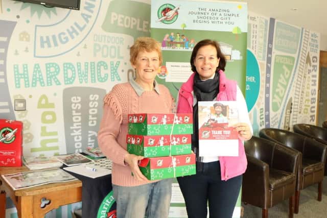 Eunice Harrodine, left, of Operation Christmas Child and office manager Rachel Attley at The Peoples Church with some of the shoeboxes the staff there packed and donated.