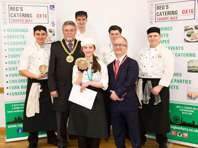 Hook Norton student Sophie Brown was winner of the 2018 Young Chef contest. She received her trophy from mayor Cllr Colin Clark. Also pictured is sponsor Reg Howe of Reg's Cafe.