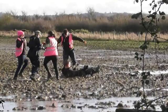 A saboteur is pictured on the ground after, it is claimed, he was barged off his feet