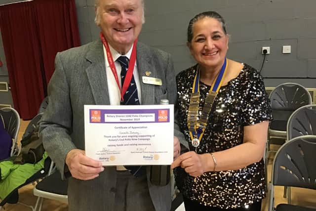Rotarian Gareth Jeremy was presented with a certificate by Rotarian president Surinder Dhesi