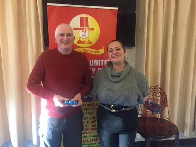 Richard of the BUFC lottery team with Diana the manager of GF Sports & Social Club