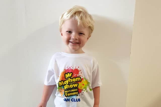 Joshua Coombes wears his Mr Mayhem Show Fan Club T-shirt