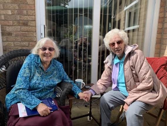Dorcas Tobin (right) enjoyed the long-awaited reuntion with her twin sister, Edith Dumbleton (left,) to celebrate their 100th birthday together on Sunday June 28.