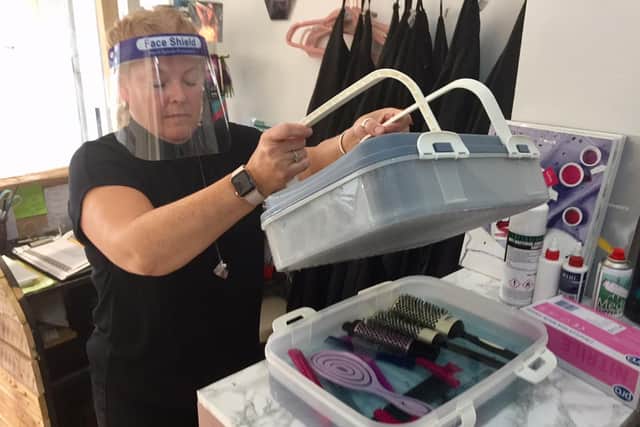 Jennie Walsh, a hair dresser at The Salon in Banbury, sanitises brushes in the salon