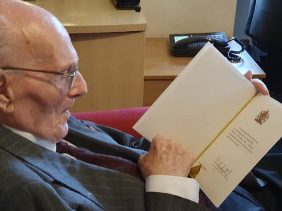 John Campion, also known as Capper to his friends and family, looking at his birthday card from the Queen