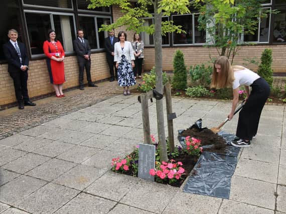 Harriet Sleem, sixth form ambassador, burying the time capsule at Chenderit School on Wednesday July 8 to mark the school's 40th anniversary