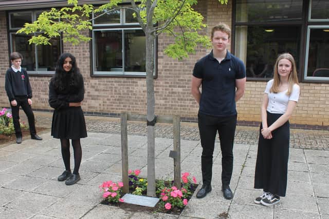 Chenderit School students: Oliver Robertson, Mayah Mohammed, Charlie Willis and Harriet Sleem stand near the time capsule buried to mark the school's 40th anniversary