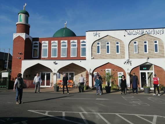 Volunteers stand outside the Banbury Mosque