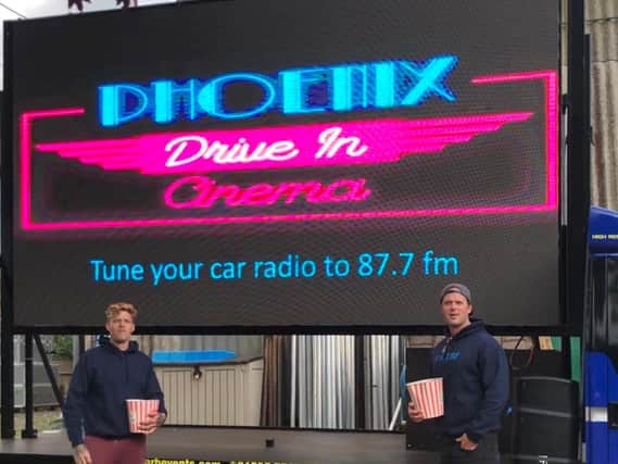 Ryan Johnson (nearside) and Jake Stevens (far side) infront of screen for Phoenix Drive in Cinemas