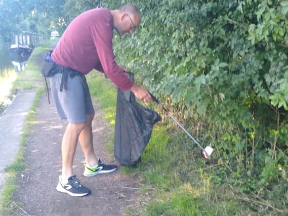 Richard MacKenzie picking up litter along the Oxford Canal in Banbury on Saturday morning July 11