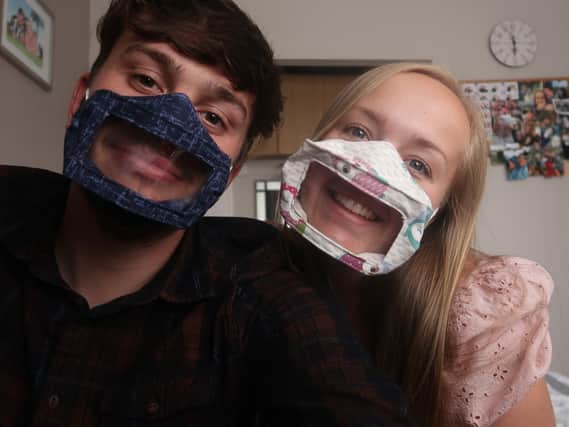 Michelle Wixey and her partner,James George wearing the face masks that help deaf people