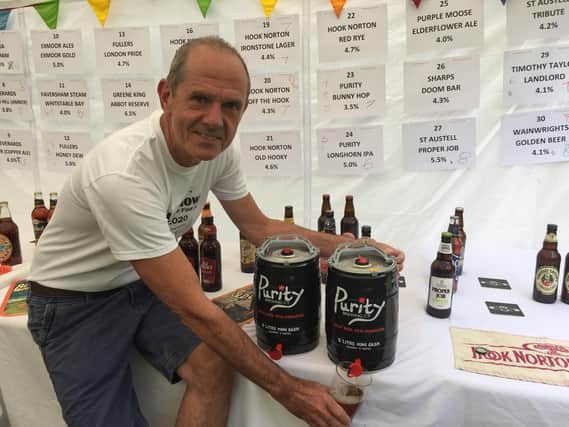 Kevin Hope pours another glass of beer at his own Father's Day Festival of Ales in Hook Norton