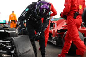 Lewis Hamilton checks out his flat tyre