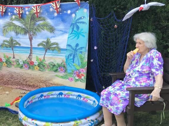 A resident at Lake House Care Home in Adderbury enjoys the beach experience