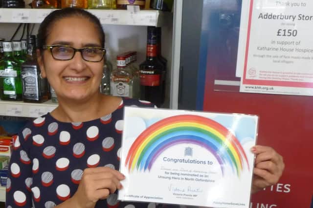 Deepa Bansal of Adderbury Stores with the Unsung Heroes award she and her husband have received from Victoria Prentis MP