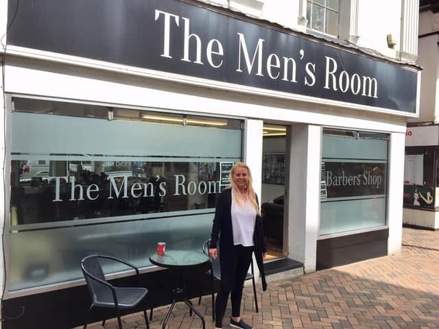 Gilly Carter stands outside her High Street barber shop, The Men's Room
