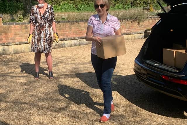 South Northamptonshire MP Andrea Leadsom helps to deliver boxes with Northamptonshire Community Larders founder Miranda Wixon in the background