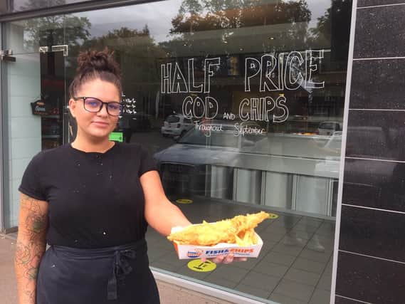 Caroline Rickard, the manager at Atlantis Fish Bar, holds a cod and chips meal which she's offering half price for the entire month of September