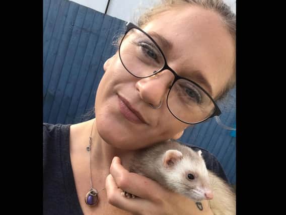 Jannine Paxton-Timms holds a ferret she rescued through the local charity BARKS