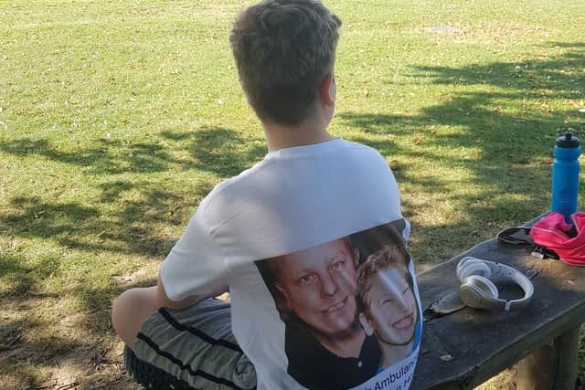 Charlie Holland wearing a T-shirt designed with a picture of him with his father.