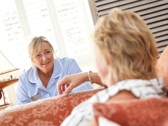 Janet Watkinson, Healthcare Assistant with Shipston Home Nursing, talks to a patient
