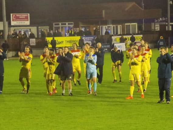 The Banbury United players applaud the travelling supporters after their fine win at Nuneaton Borough on Tuesday night. Picture by Dave Shadbolt
