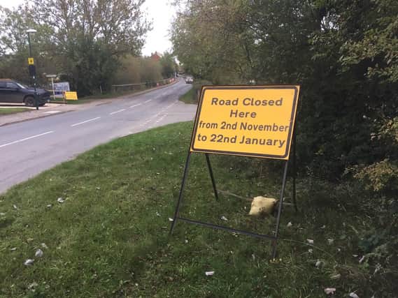 A road closure sign posted on the roadside for Warwick Road at the junction of Brookhampton Lane, which is a major through road for the village.