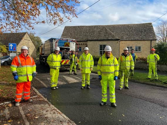 Cllr Liam Walker front centre with contractors from Hazell & Jefferies carrying out micro asphalt work in Carterton in October.