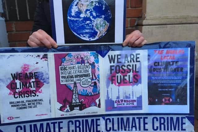 Members of Extinction Rebellion Banbury put up posters and stickers outside the Barclays and HSBC bank branches in Banbury as part of a protest to the funding of fossil fuel extracting companies.