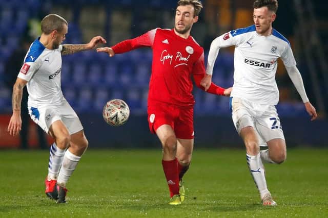 Brackley's Shane Byrne squeezes in between Tranmere's Jay Spearing and Paul Lewis