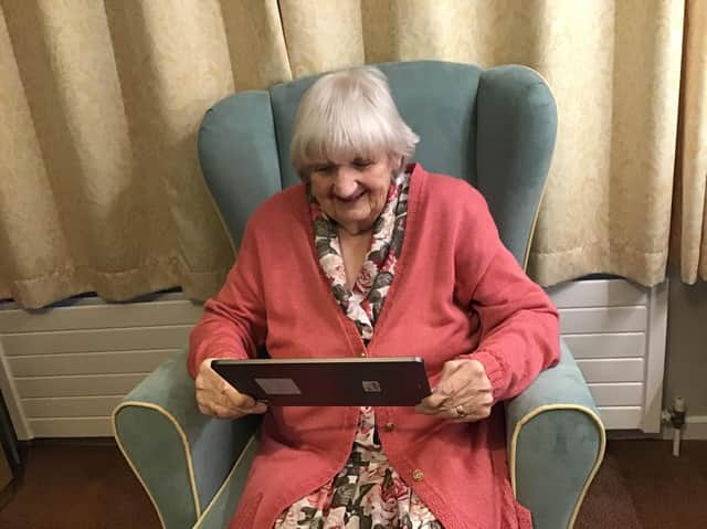 Lake House Care Home in Adderbury resident, Dorothy Lund, enjoying interaction on the iPad.
