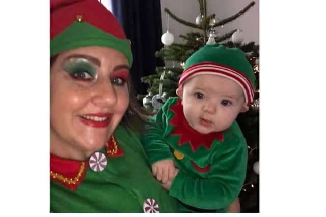 Stephanie Silver and her five-month-old son Niko in their elf outfits.