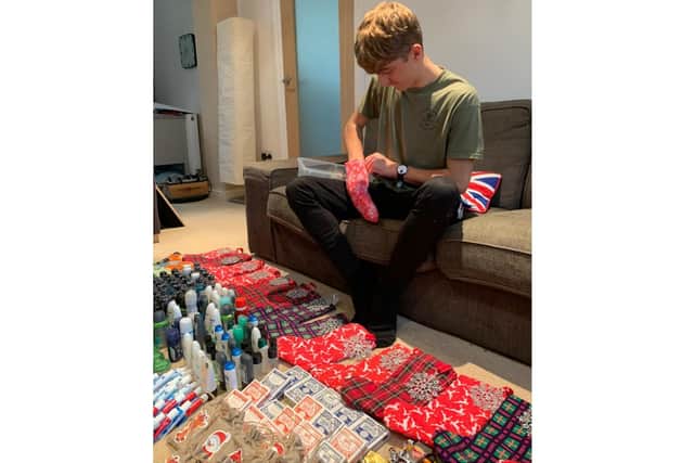 Aaron Speke working on the Christmas stockings he made for soldiers serving abroad