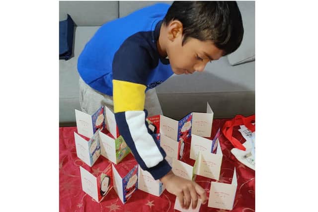 Prabhu's son, five-year-old Addhu, prepares the Christmas greeting cards he made