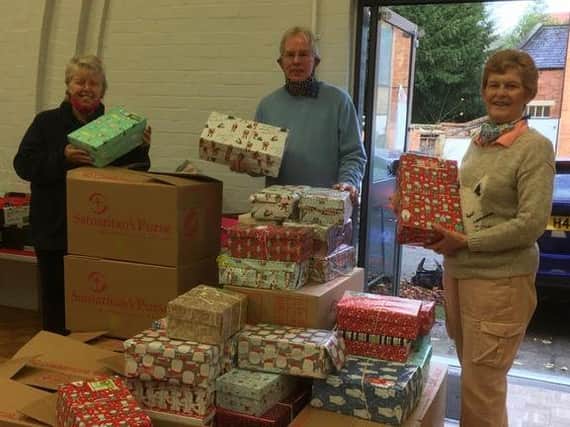 Pictured from left to right, Sue and Geoff Smith and Eunice Harradine with a consignments of shoeboxes for Operation Christmas Child