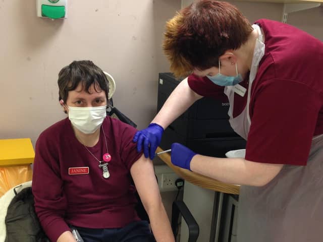 Janine Cross a care worker at the Julie Richardson Nursing Home is given her Covid vaccination by GP Dr Gwyneth Rogers