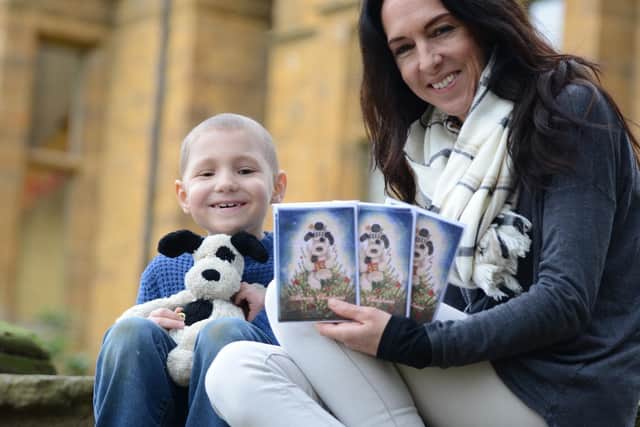 Freddie Croft with teacher Wendy Price who designed a Christmas card that has raised over £6,000 for research into the bone cancer Freddie has