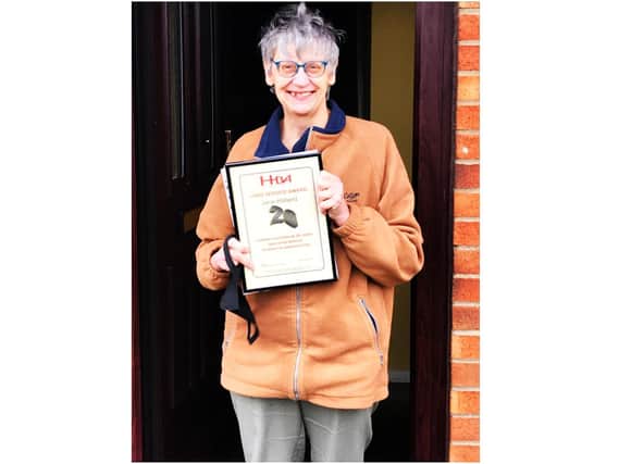 Jane Holland receives her long service certificate for 20 years from the Hospital Broadcasting Association (HBA) (photo from Radio Horton)