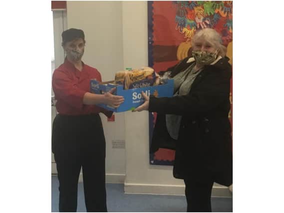 St Mary's Church of England Primary School staff members, Lorriane Stickley and Ruth Anker, with a food parcel which was delivered this week in Banbury (photo from St Mary's Primary)