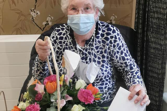 Mary Sheppard with the flower arrangement she was presented with by husband John on their 65th wedding anniversary