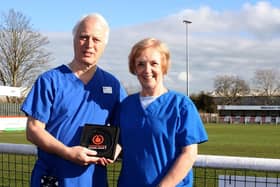 Dr Philip Stevens and his wife Denise show off their Vanarama National League North Volunteers of the Month award for January after their efforts at Brackley Town. Picture courtesy of Brackley Town FC