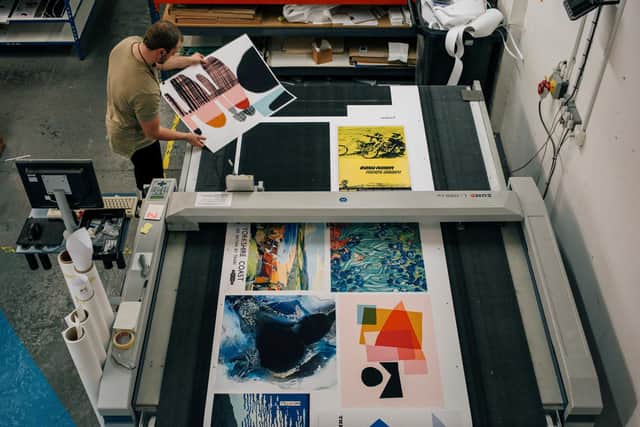 The print press at King and McGraw and a selection of prints from the museum. Photo supplied